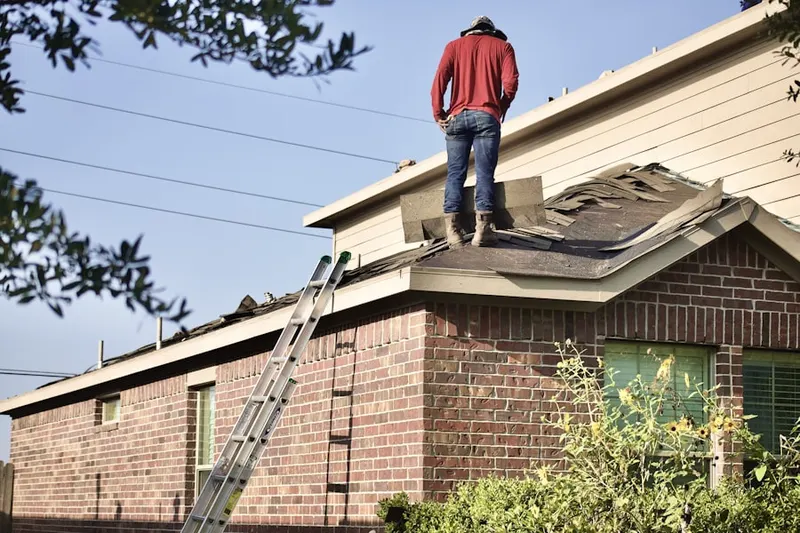 Professional roofer working on a residential roof in Lakes of Bridgewater